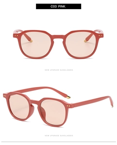 Close-up of pink retro square sunglasses featuring decorative metal rivets and light lenses