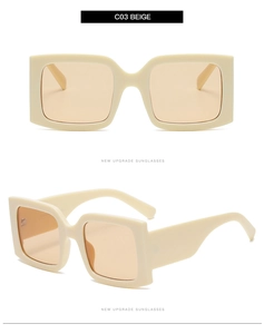 Detail view of beige square sunglasses with thick temples and light orange lenses