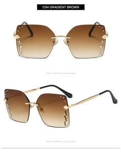 Detail showing oversized gradient brown lenses and ornate gold metal frame with rhinestones