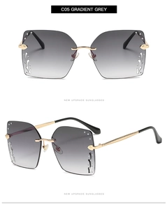 Detail view of large square sunglasses with gradient grey lenses and rhinestone accents
