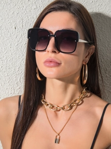 Close-up of square gradient sunglasses with silver metal temples on female model