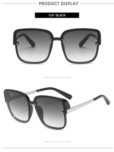 Detail view of square black sunglasses with gradient lenses and silver metal temples