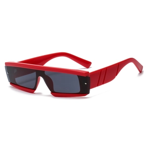 Detail of red square sunglasses with thick grooved temples and dark rectangular lenses