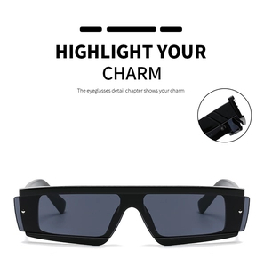 Detail view of bold black rectangular sunglasses featuring metal rivet accents
