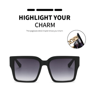 Detail of square oversized sunglasses featuring golden chain metal temple accents