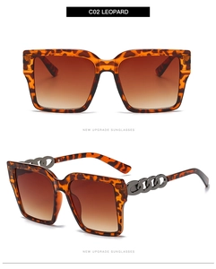Detail of leopard print square sunglasses with decorative metal chain on the temple