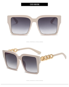 Detailed view of beige square oversized sunglasses with gold metal chain link on temples