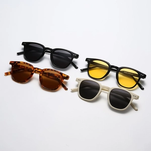 Lunettes de soleil rondes vintage avec montures noires, écaille et crème et rivets