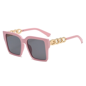 Retro oversized square sunglasses with pink frames and bold gold chain temples