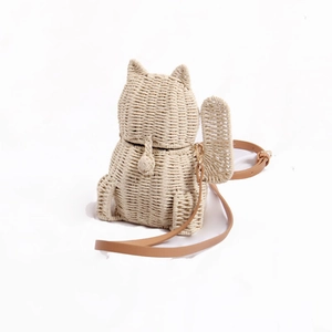 Lucky cat straw crossbody bag for kids featuring kitten ears and a brown leather strap