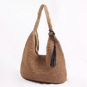 Brown woven straw hobo bag with fringe tassel detail and large capacity for beach travel