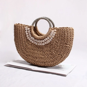 Handmade semicircular straw handbag with white shell decor and striped round handles