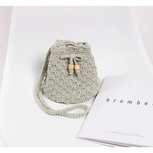 Handmade crochet woven bucket bag in mint green with drawstring and wooden beads