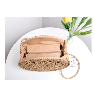 Handmade hollow round straw shoulder bag for beach vacation with zipper compartment