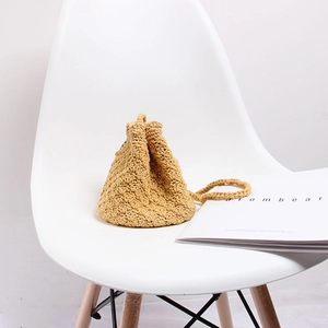 Detail of yellow handmade crochet crossbody bag with textured scales and drawstring