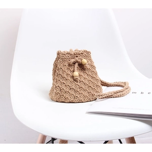 Handmade crochet straw bucket bag in light khaki with drawstring and wooden beads