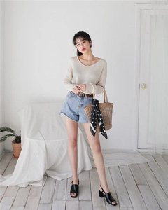 Full view of casual summer outfit featuring straw tote bag and white knit top