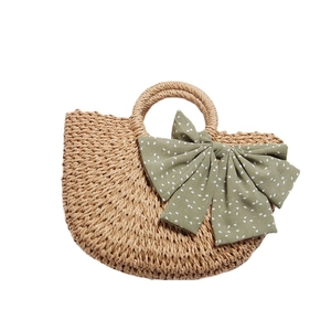 Handmade straw woven handbag with green polka dot bow for beach holidays and summer travel