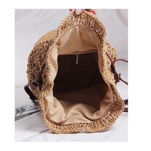 Internal view of straw woven beach bag with fabric lining and zippered pocket