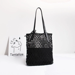 Handmade black woven mesh tote bag with leather handles for beach vacation style