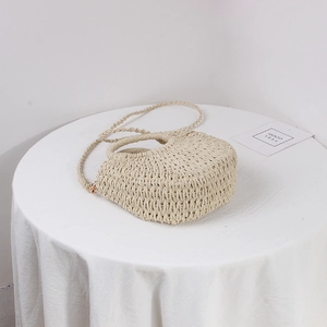 Chic cream straw woven half-moon crossbody bag with top handle for summer vacation