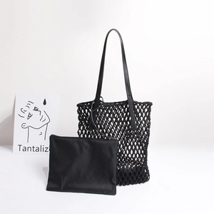 Detail of black woven mesh beach bag set with matching inner pouch and leather shoulder straps