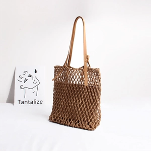 Detail of camel woven mesh tote bag with fine rope knots and slender leather handles