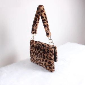 Detail view of leopard print plush bag showing soft faux fur texture and gold metal ring