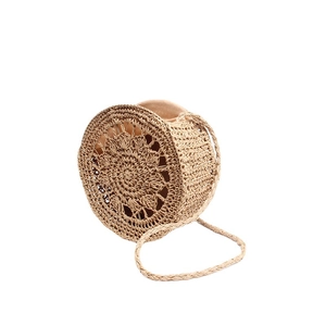 Handmade hollow round straw shoulder bag for summer beach vacations in natural woven style