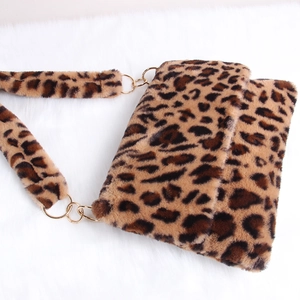 Detailed macro view of soft leopard print faux fur texture and golden metal ring hardware