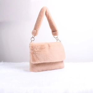 Detail of pink faux fur shoulder bag featuring round gold rings and soft plush strap