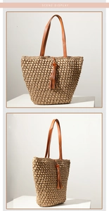 Detail of straw tote bag with brown leather straps and decorative tassel on white stand