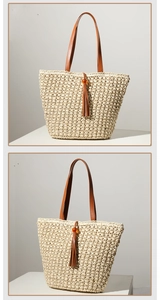 Detail view of woven straw tote bag featuring white fringe tassels and amber beads decoration