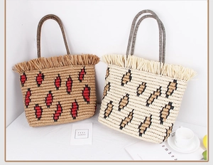 Close-up of woven straw tote bags with leopard print patterns and stylish fringe details