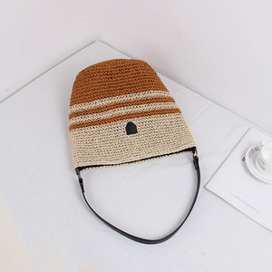 Minimalist striped straw bucket bag with brown and beige weaving and leather shoulder strap
