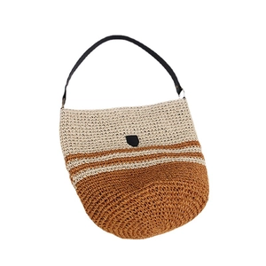 Striped straw shoulder bag with black leather shield and handle for beach vacations