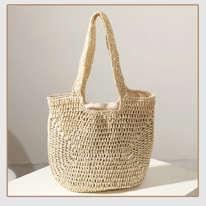 Close-up of the woven texture and fabric lining of this handcrafted straw tote bag