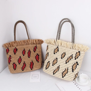 Fashionable straw tote bag with leopard print texture and raffia tassels for summer beach