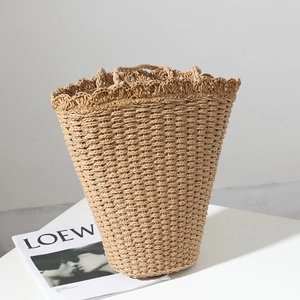Handcrafted straw tote bag with scalloped edge detail for beach vacations and summer trips