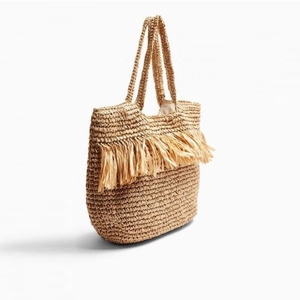 Bohemian woven straw tote bag with fringe tassels and large capacity for beach vacation