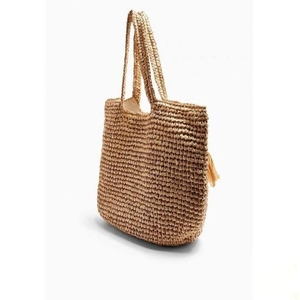 Handwoven straw tote bag with fringe tassels for summer beach vacation and daily use