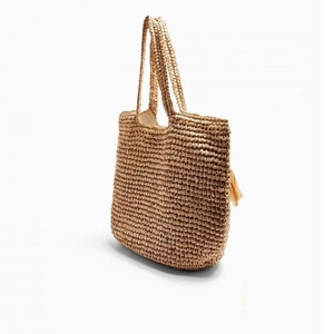 Large woven straw tote bag with tassel detail for summer beach vacations and daily use