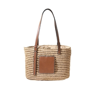 Square woven straw tote bag with brown leather straps and drawstring fabric lining