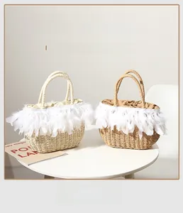 Detail of hand-woven straw tote with elegant white feather trim for summer beach vacation