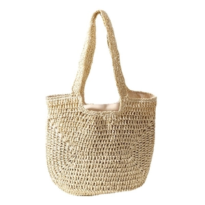 Large hand-woven straw tote bag with beige textured finish and sturdy shoulder handles