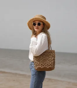 Detailed view of handmade hollow flower crochet beach bag with vintage woven texture