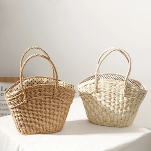 Detail of straw woven tote with polka dot lining and secure drawstring closure mechanism