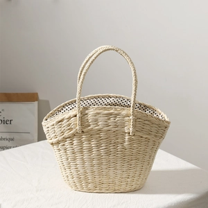 Beige straw tote bag with polka dot lining and woven handles for summer beach vacation