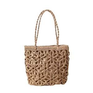 Handmade woven hollow flower straw bag for beach vacation with shoulder strap