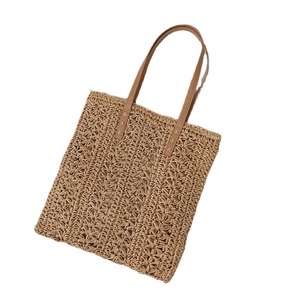 Large straw tote bag with brown leather handles for summer beach vacation and daily use